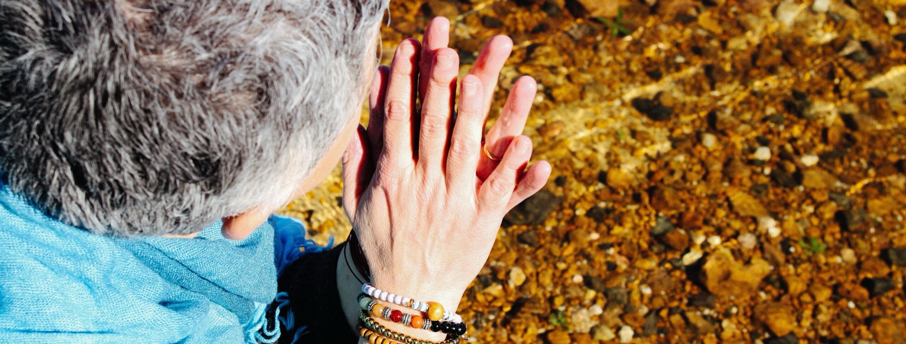 Marye O'Brien's hands held over warm stones