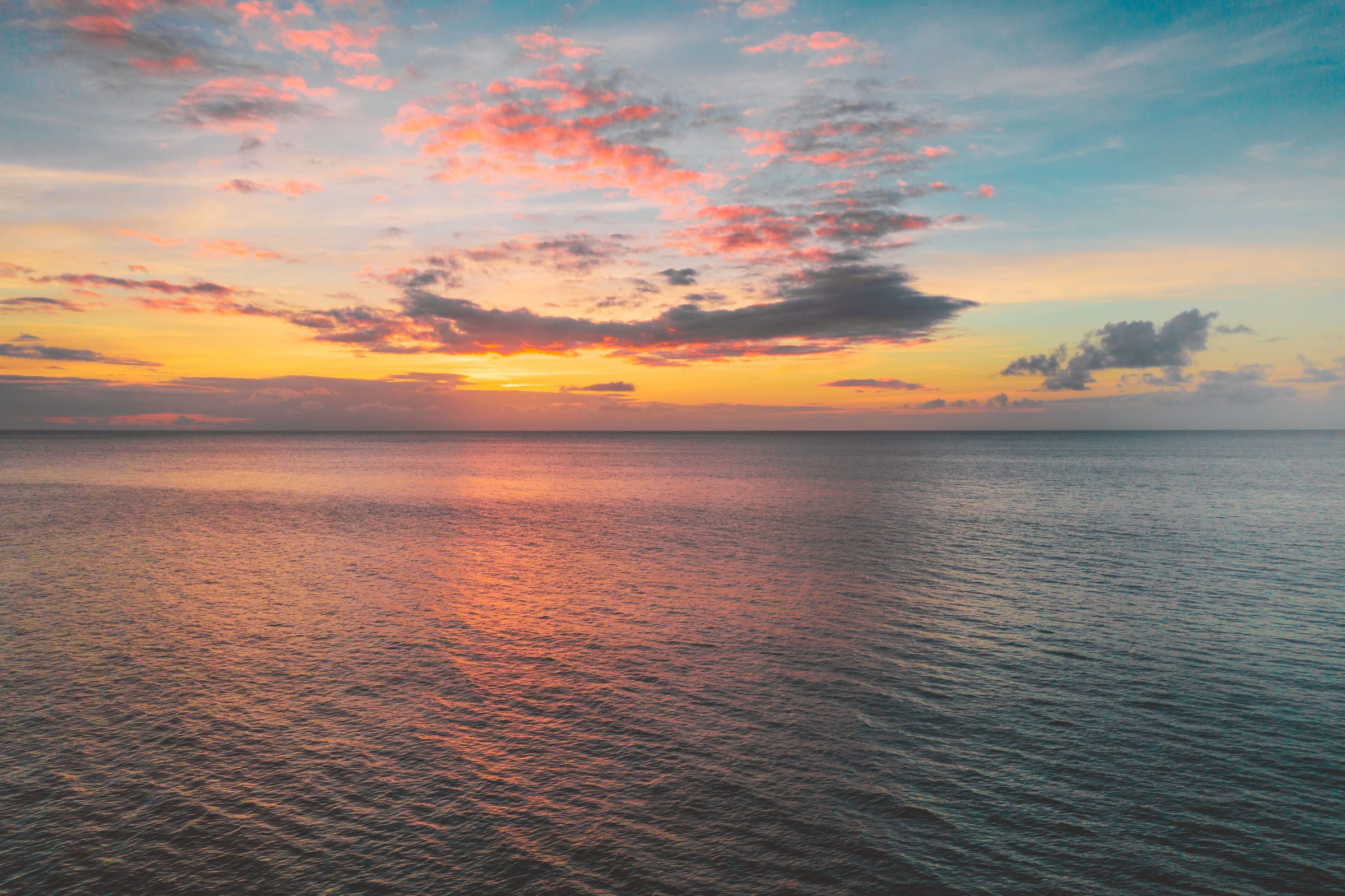 Pink cloud over the sea at sunset
