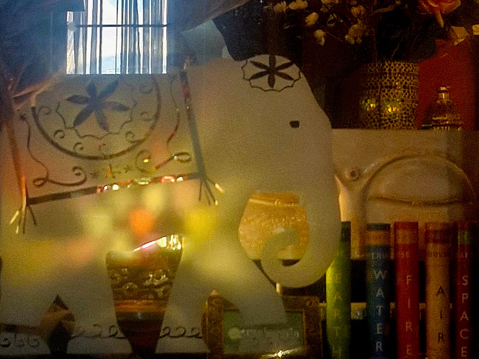 The white elephant on Maiaveda's window, with star lanterns and books on the five elements