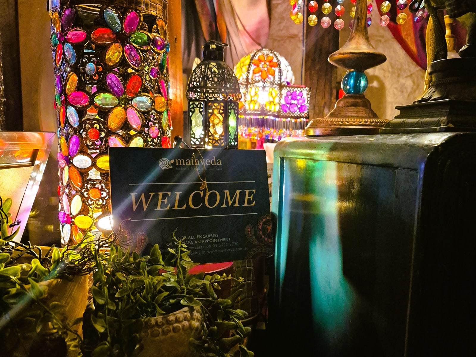 The Maiaveda welcome sign among coloured glass lanterns in reception