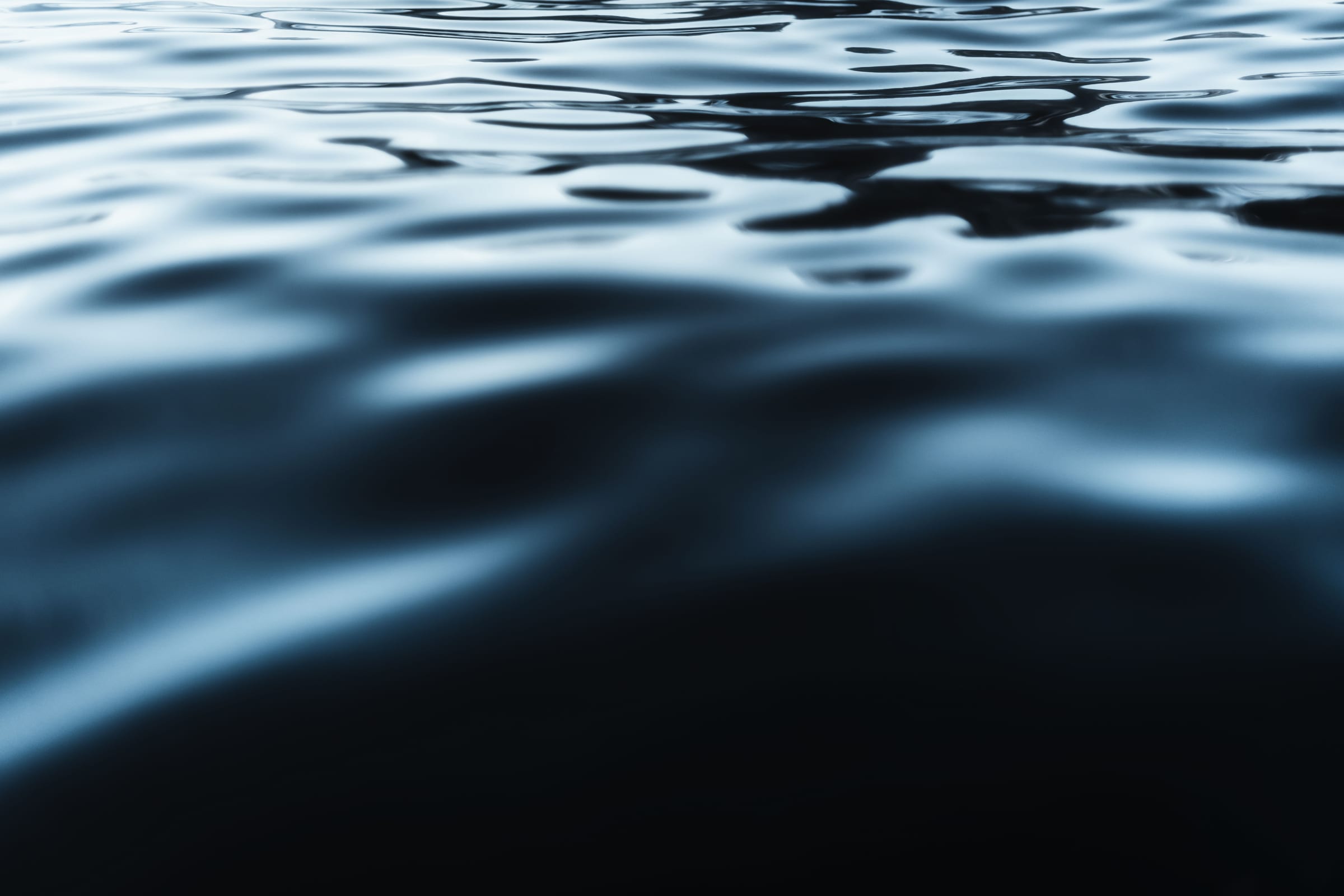 Dark water moving in slow ripples