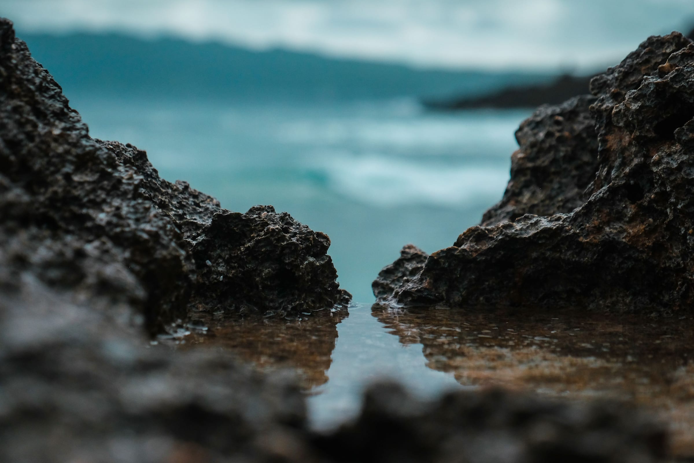 The sea between two dark rocks, waves beyond